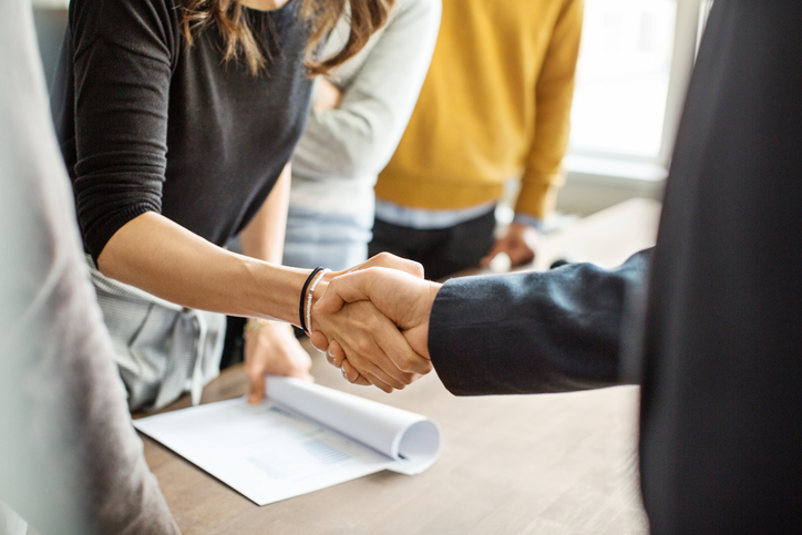 Business people shaking hands in office Business people shaking hands in office
